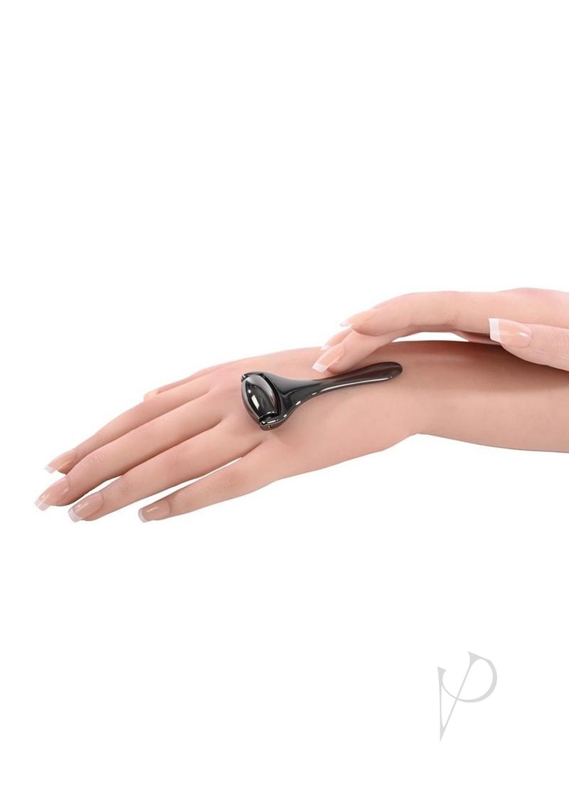 Sex and Mischief Ex's & Oh's Temperature Play Roller Black being used on a hand for temperature play stimulation.