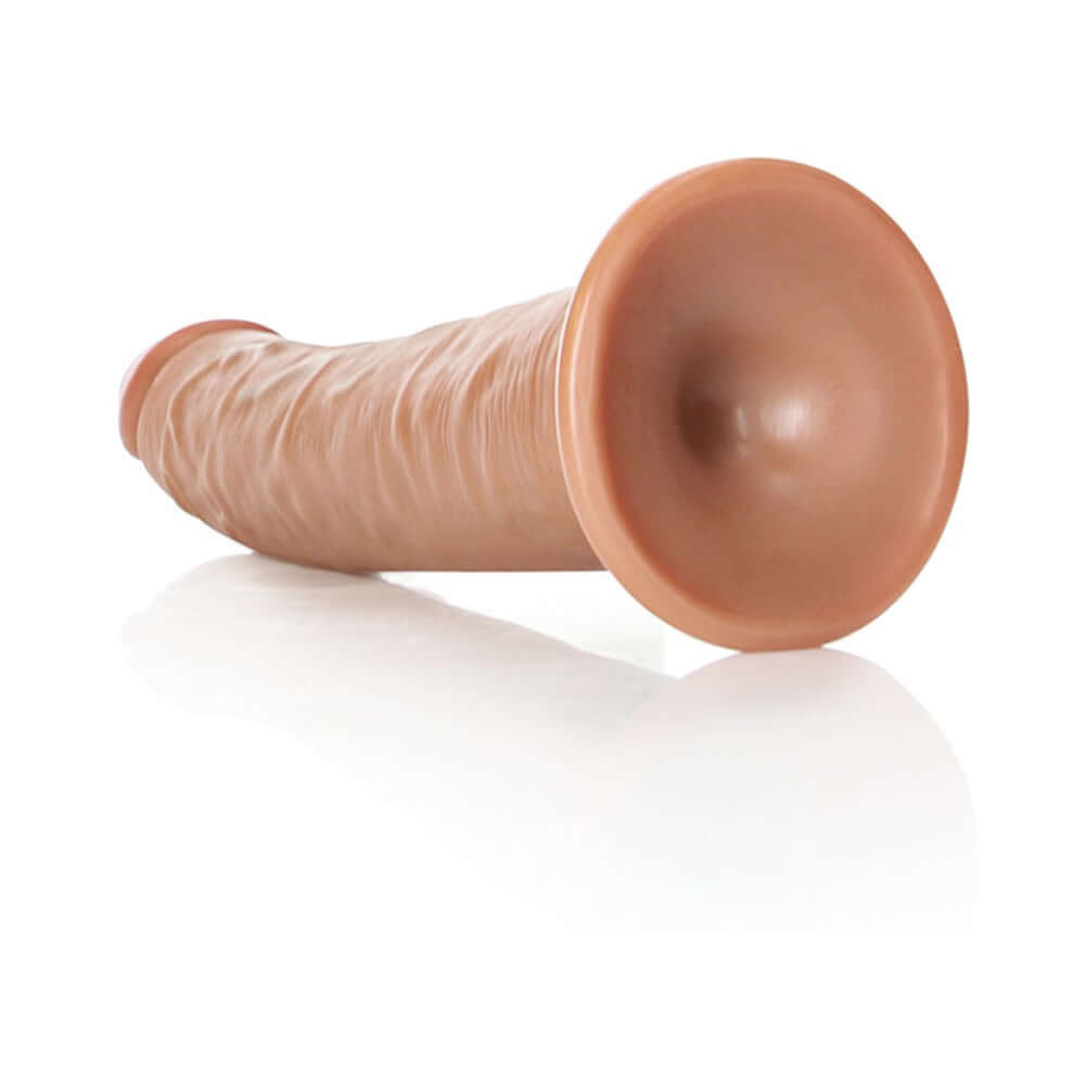 RealRock Realistic 8 inches Slim Dildo With Suction Cup Tan displayed on a reflective surface.