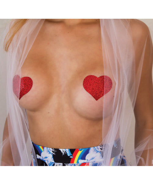 Pastease Glitter Heart Red Nipple Pasties applied on skin, featuring bold red glitter heart shapes.