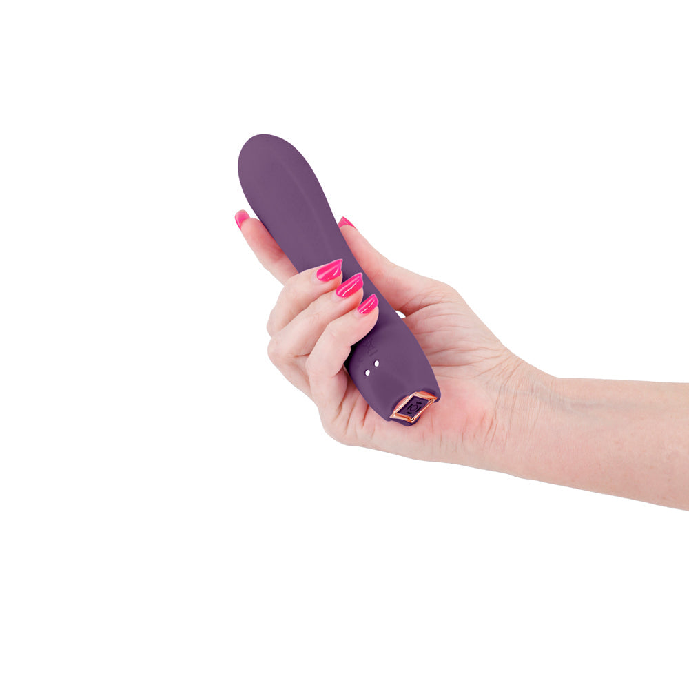 Obsession Romeo Vibrator Dark Purple held in hand, showcasing its sleek design and vibrant color.