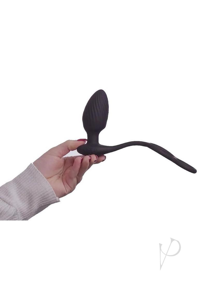 Nexus Tornado Rotating Butt Plug and Cock Ring Black held in hand, showcasing its design and functionality.