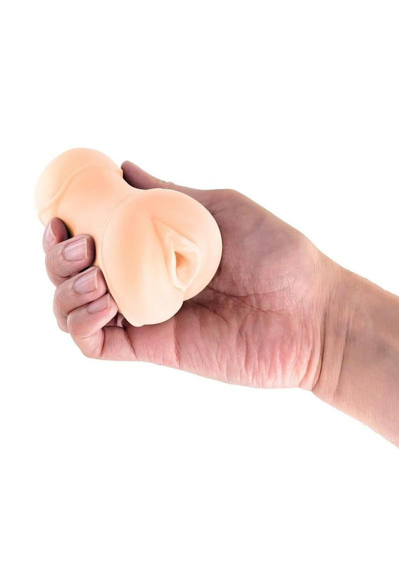 Pocket Pals Stroker Pussy Beige held in hand, showcasing its realistic design and soft texture.