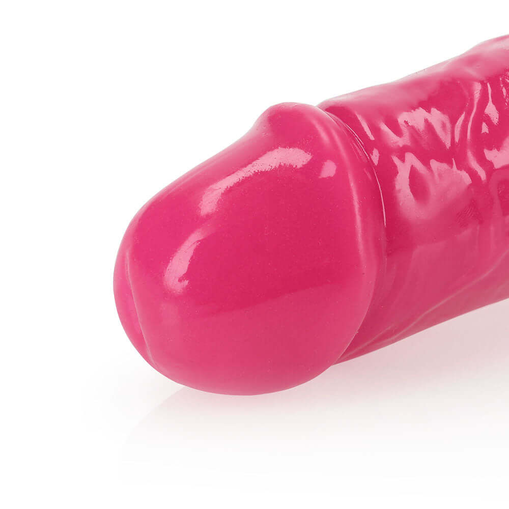 RealRock Glow in the Dark Double Dong 12 inch Neon Pink close-up view of the tip highlighting its vibrant color and design.