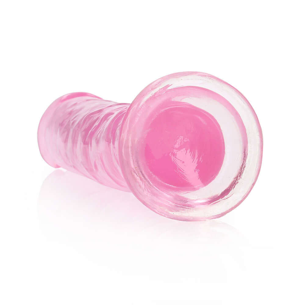 RealRock Crystal Clear Straight 7 inches Dildo Pink showcasing sleek design and transparent silicone-style finish.