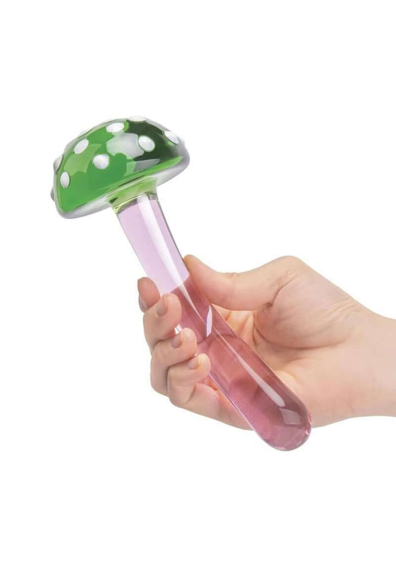 Glas Magic Mushroom Glass Dildo 7.5 inches held in hand, featuring a green cap with white dots and a pink stem.