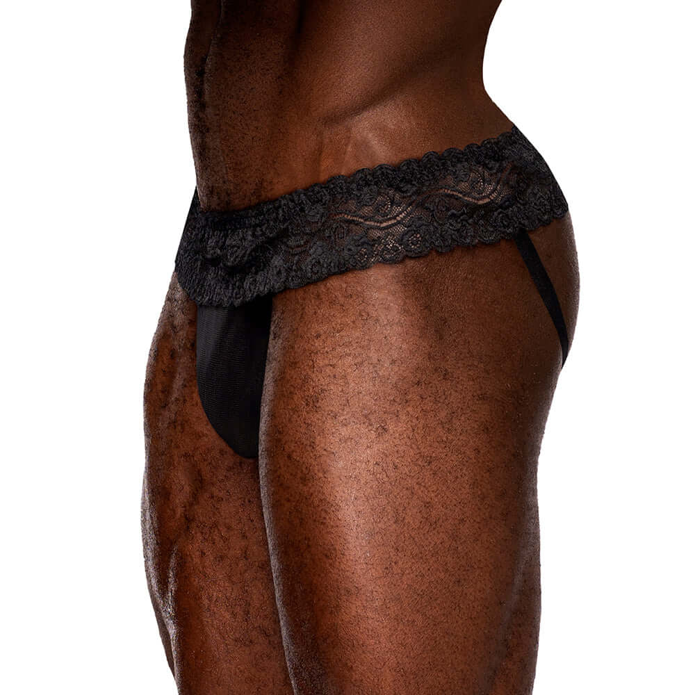 Male Power Sassy Lace Skirt Jock Black S M showcasing lace ruffled skirted waistband and sheer stretch mesh pouch.