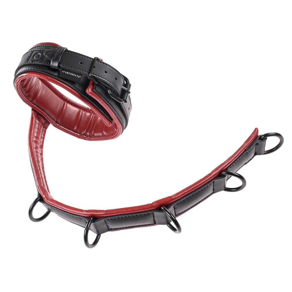 Sportsheets Saffron Adjustable Neck & Wrist Restraints in red and black, designed for immersive bondage play.