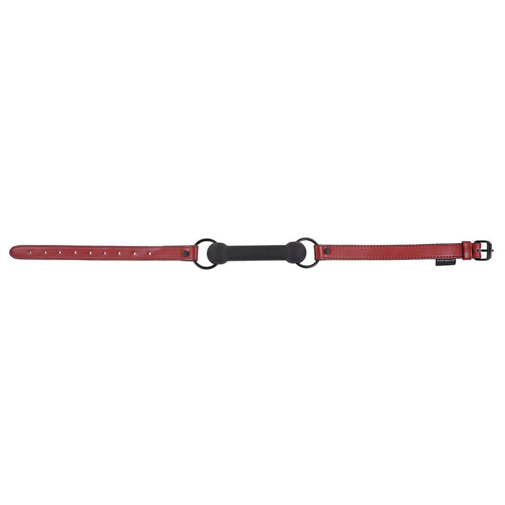 Sportsheets Saffron Silicone Bit Gag with Adjustable Buckle in red, featuring adjustable straps and a durable design.
