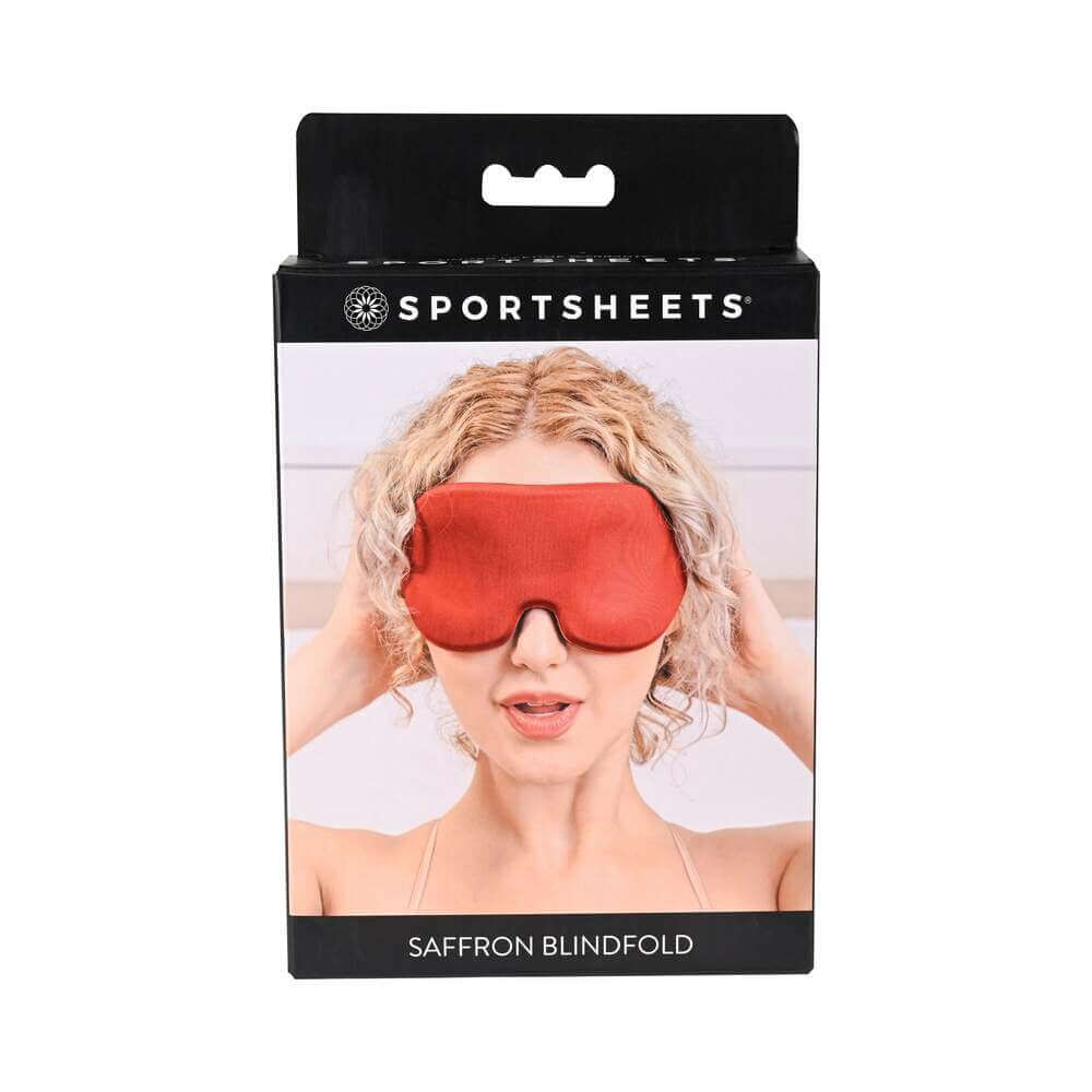 Sportsheets Saffron Blindfold with Memory Foam packaging featuring a woman holding the blindfold.