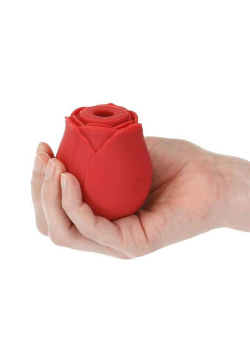 M Lady Rose Rechargeable Clitoral Suction Stimulator Red held in a hand, showcasing its rose shape and design.