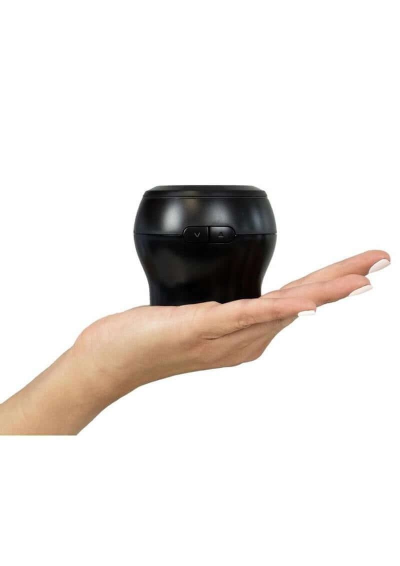 Kiiroo PowerBlow Interactive Suction BlowJob Device held in hand, showing compact design and control buttons.