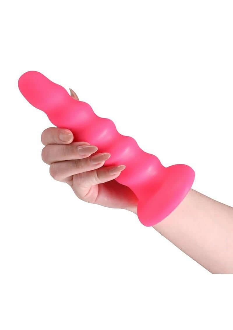 Colours Twist Silicone Dildo with Suction Cup 6.5 Inch Pink held in a hand, showcasing its soft, contoured design.