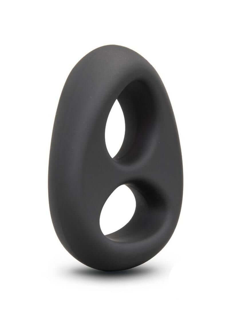 B-Vibe Flex Ring Eight Silicone Cock Ring Black displayed at an angle on a smooth surface.