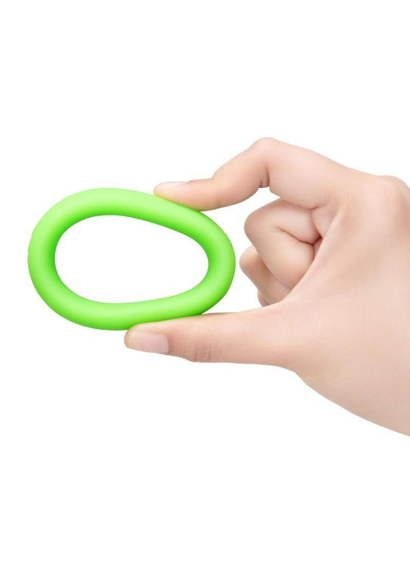 B-Vibe Snug Ring Silicone Cock Ring 45 mm Green held in hand showcasing its smooth design.