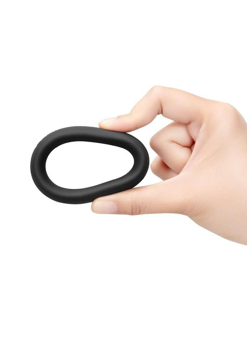 B-Vibe Snug Ring Silicone Cock Ring 45 mm Black being held in hand, showcasing its smooth design.