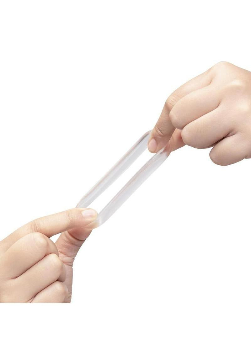 Two hands stretching the B-Vibe Stretch Tech Choke Cock Ring Clear, showcasing its flexibility and durability.