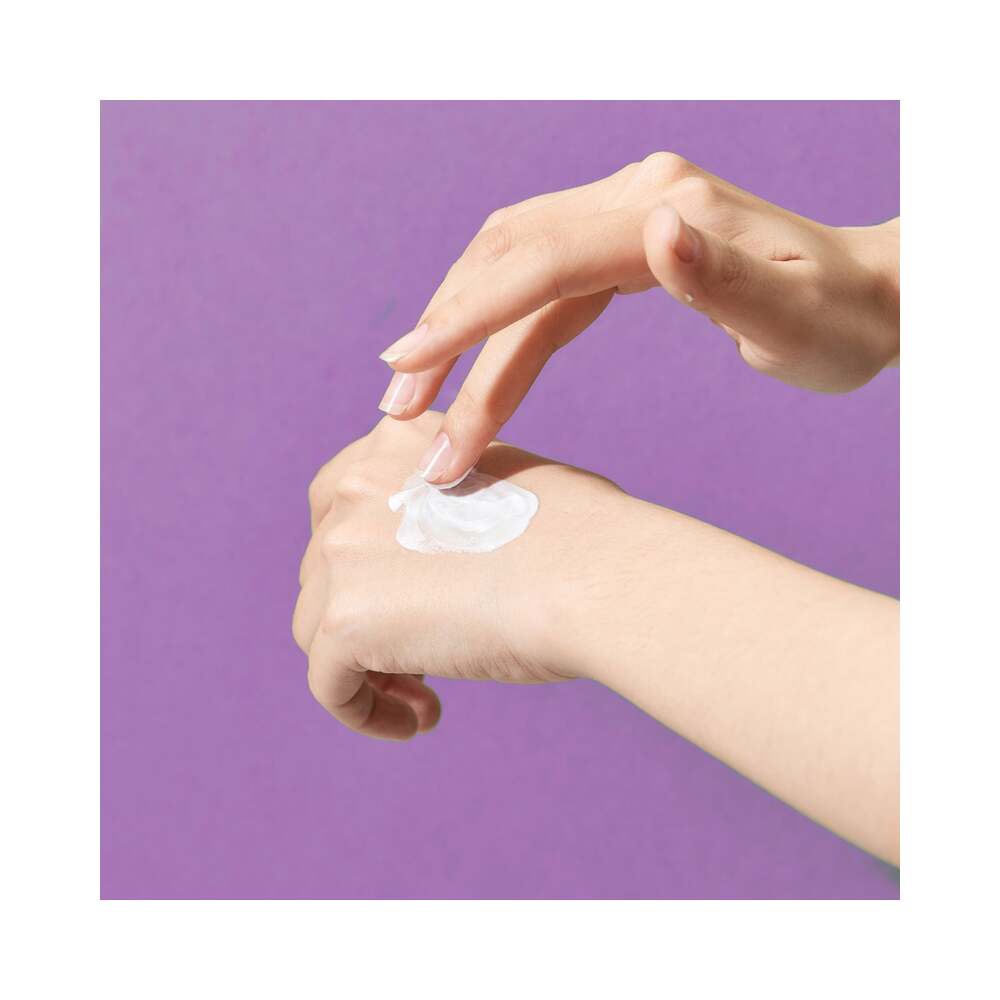 Bijoux Indiscrets Its a Match Liquid Vibrator Tingling 0.34 Oz applied on hand against a purple background.