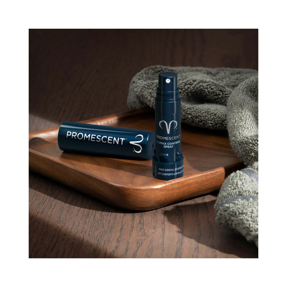 Promescent Climax Control Desensitizer Spray 0.09 Oz displayed on a wooden tray with a towel.