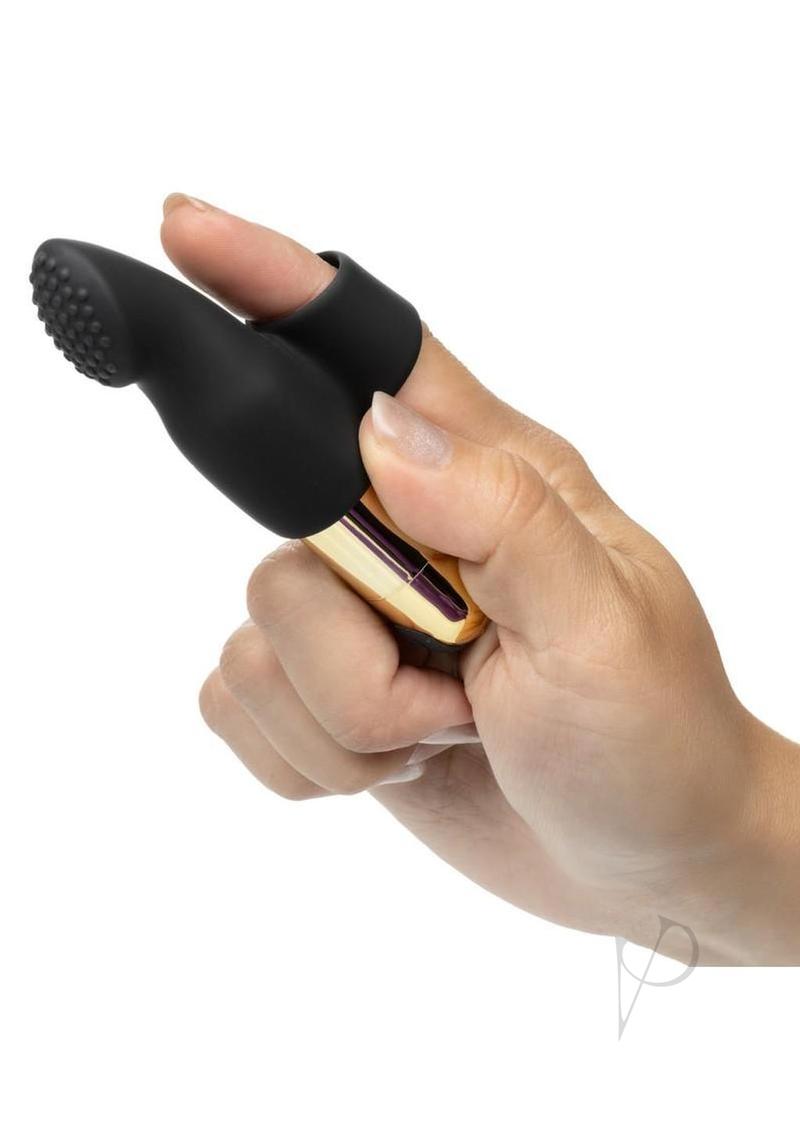Pleasure Kits Untamed Collection Bondage Kit rechargeable bullet held in hand for sensory exploration.