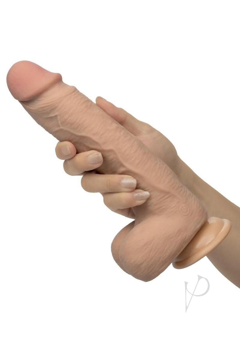 Working Stiff Shaft Slide Lumberjack Vibrating Dildo Vanilla held in hand, showcasing its realistic design and texture.