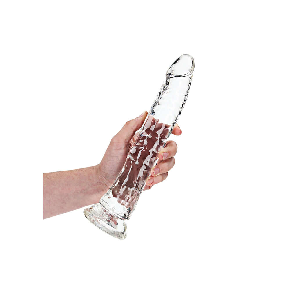 Realrock Crystal Clear Slim Dildo 10.5 inches held in hand, showcasing its clear, textured design for precision stimulation.