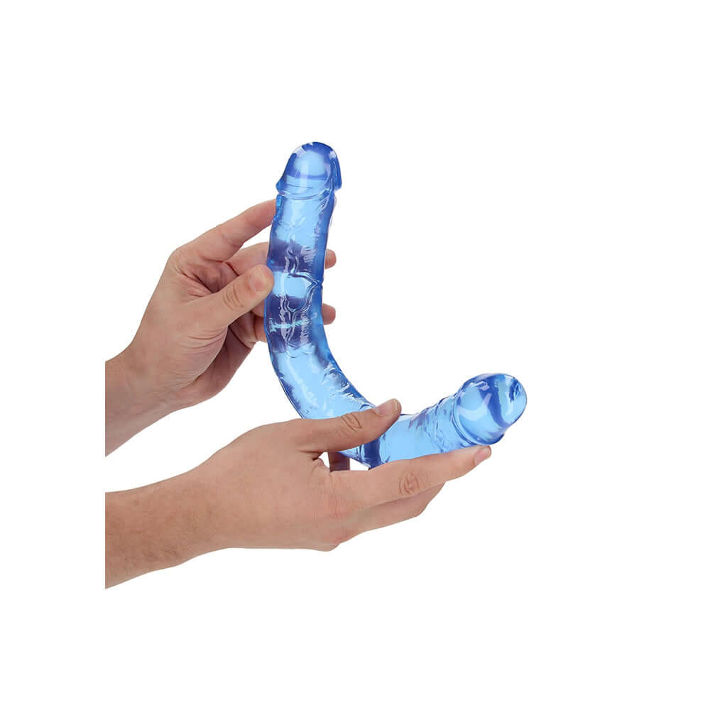Realrock Crystal Clear Double Dong 13.4 inches Blue held in hands, showcasing its transparent design and dual ends.