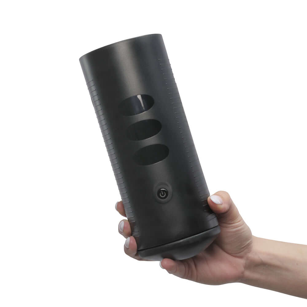 Kiiroo Titan Experience Interactive Vibrating Stroker held in hand showcasing its ergonomic design and control features.