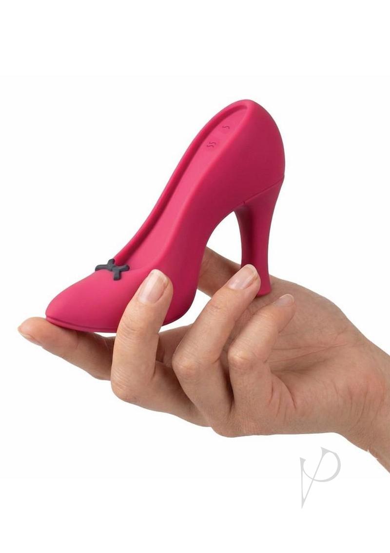Power Pump Dual Motor Rechargeable Silicone Vibrator Red in the shape of a high heel shoe held in hand.