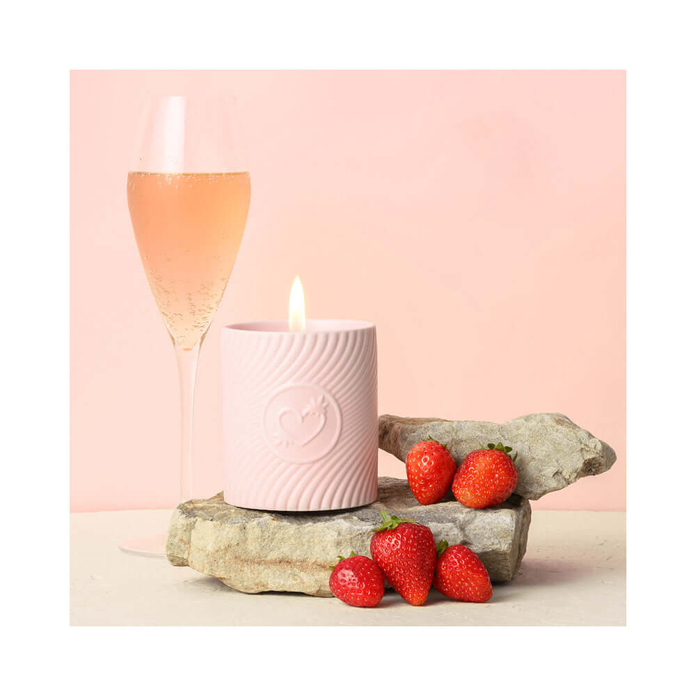 HighOnLove Pink Massage Candle Strawberries & Champagne with strawberries and sparkling champagne.