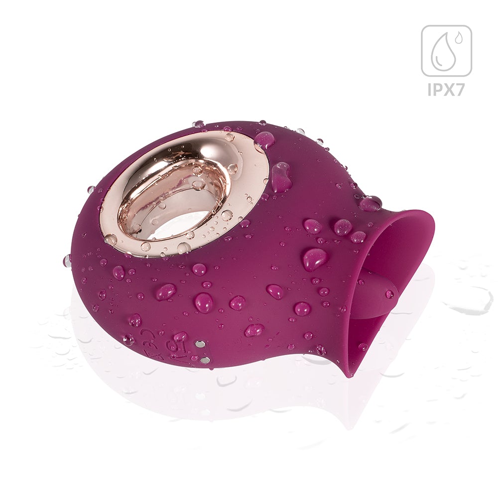 Honey Play Box Alvina Tongue Licking Clitoral Vibrator in purple with water droplets, showcasing its elegant, flexible design.