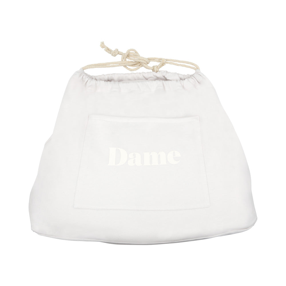 Dame Pillo Sex Pillow Oat storage bag with drawstring, featuring a front pocket.