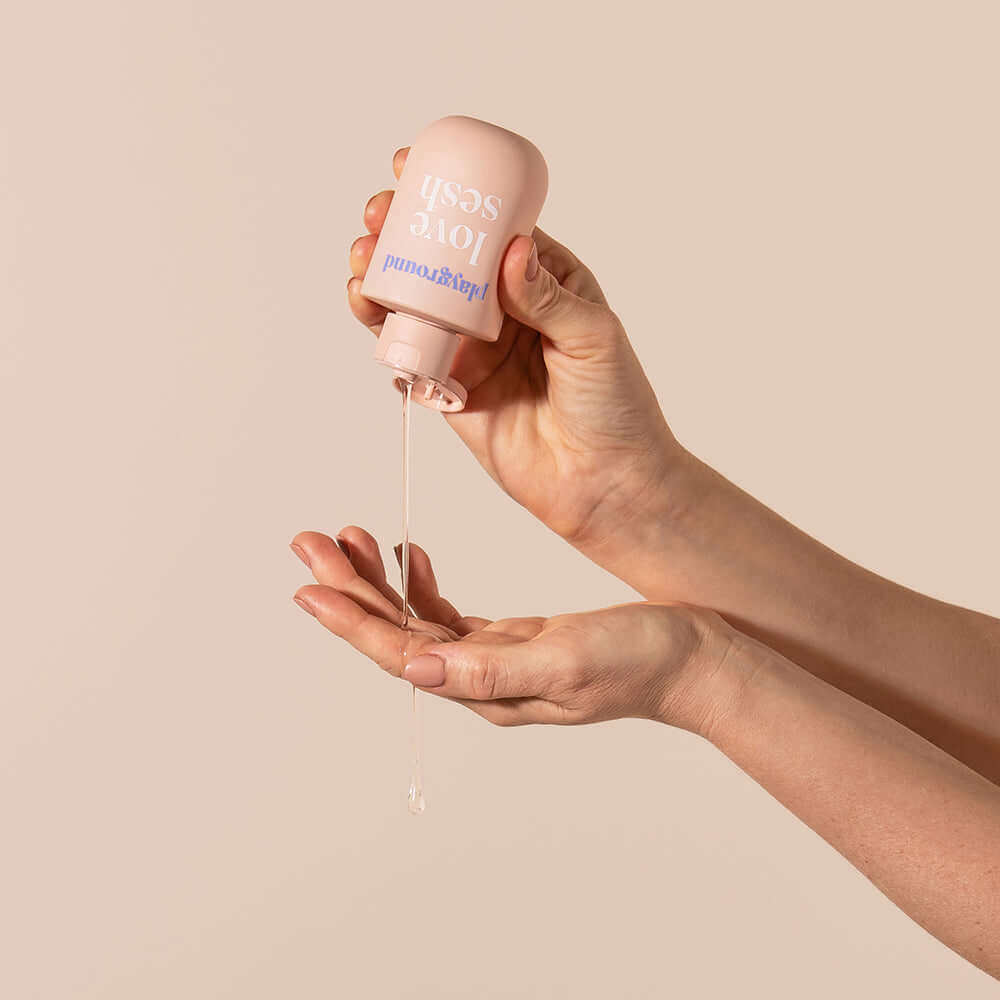 Playground Love Sesh Water-Based Personal Lubricant 3.7 Oz being poured into a palm.