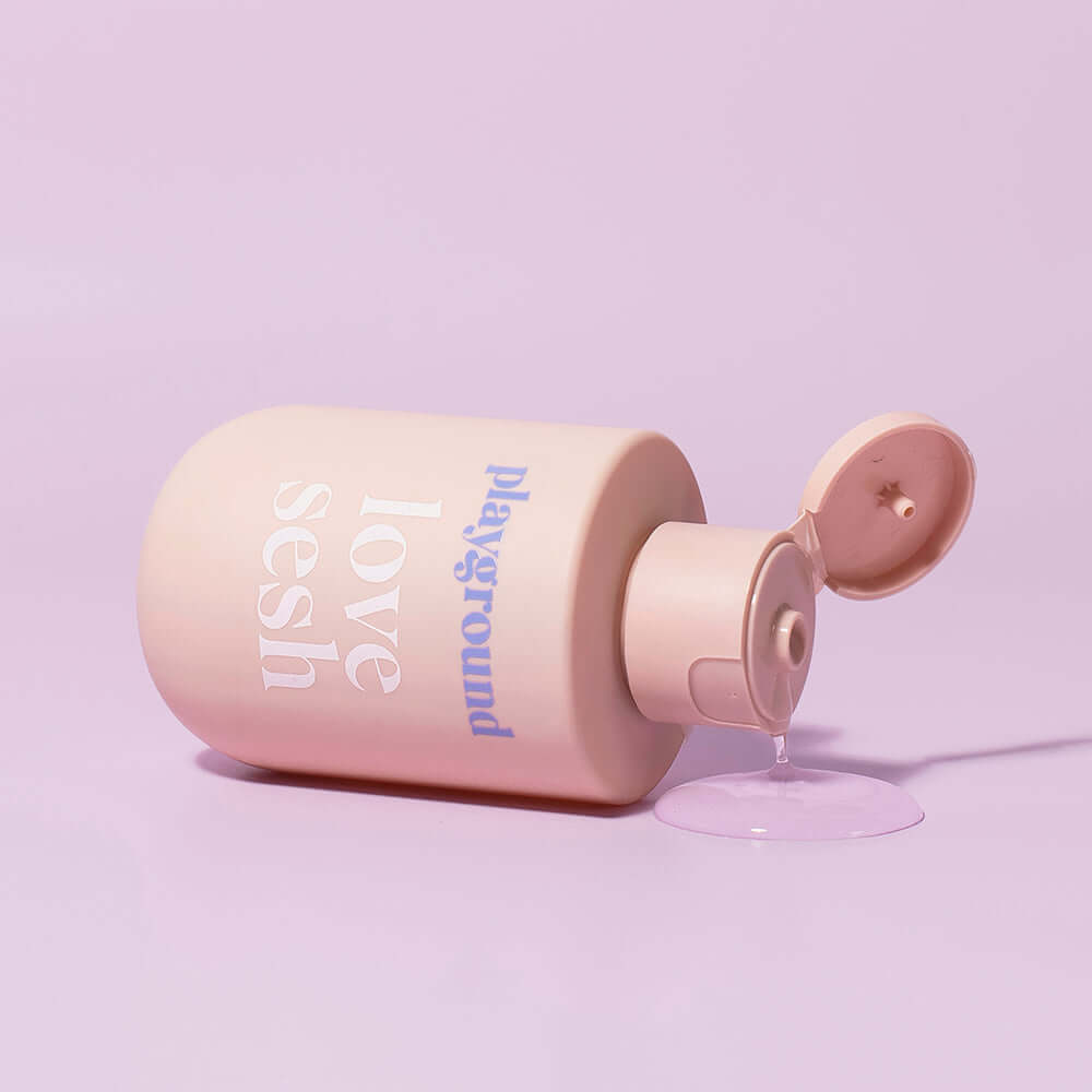 Playground Love Sesh Water-Based Personal Lubricant 3.7 Oz bottle on a pastel background