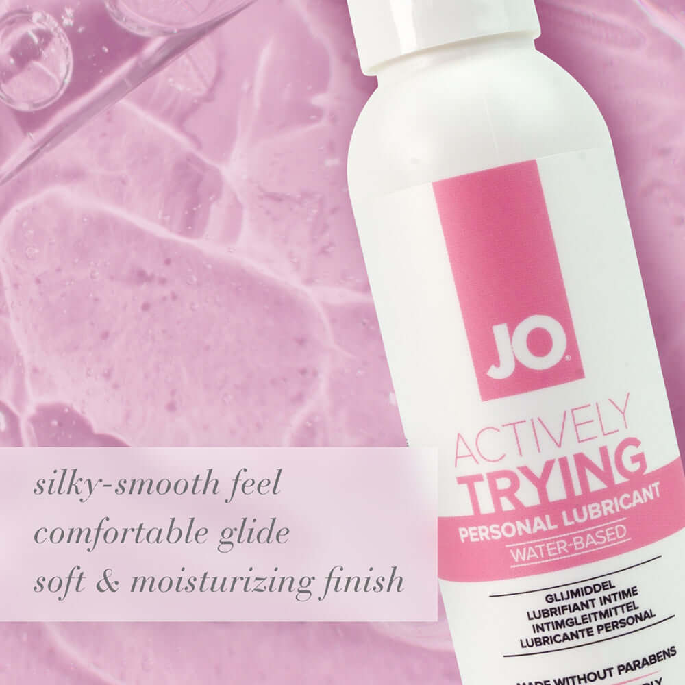 JO Actively Trying Paraben-Free Water-Based Lubricant 4 Oz bottle on a pink background.