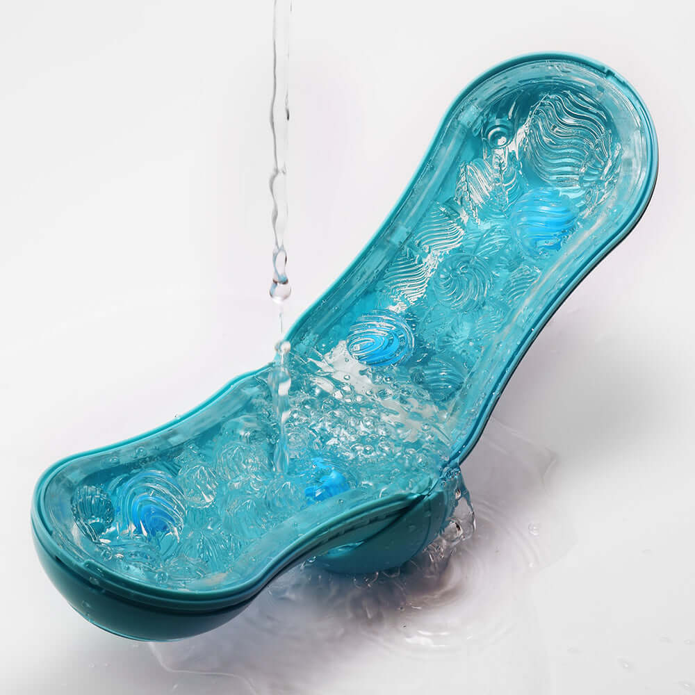 Tenga Flip Orb Ocean Blue Stroker with water droplets, showcasing its sleek design and textured interior.