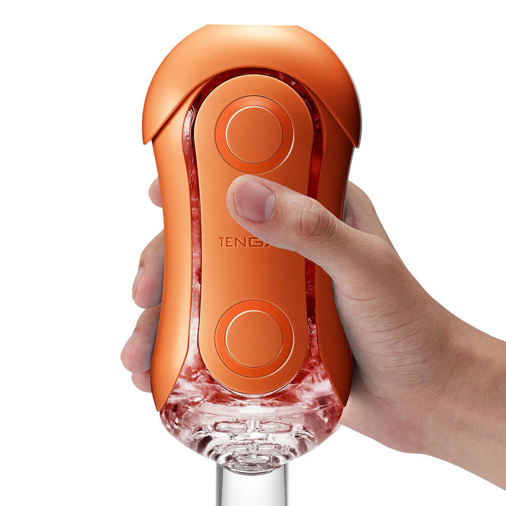 Tenga Flip Orb Sunset Orange Stroker being held, showcasing its design and texture.