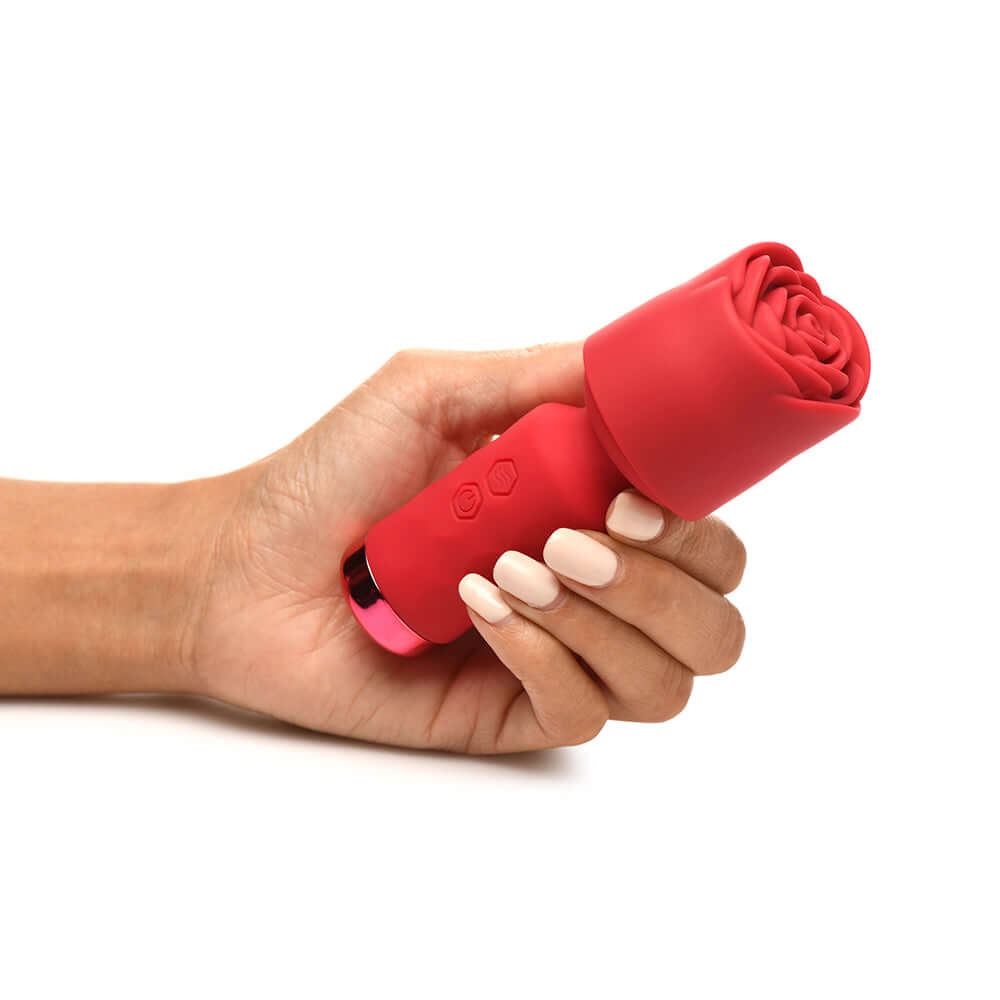 Hand holding the Bloomgasm Pleasure Rose Petite Mini Silicone Rose Wand, a compact and discreet pleasure toy.