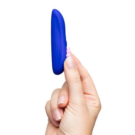ROMP Party Wearable Panty Vibrator Purple held in hand showcasing its design and remote control features.