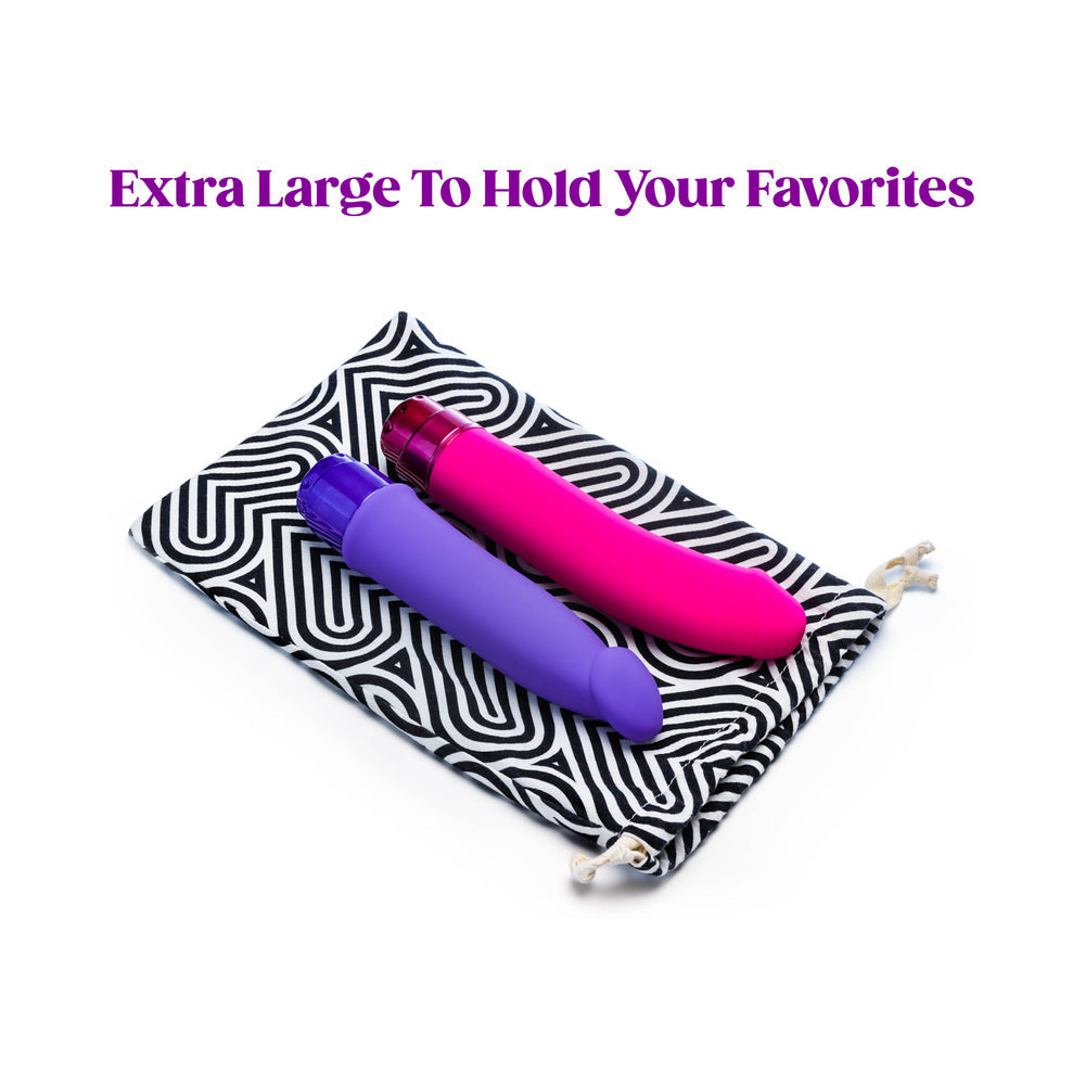 The Collection Bomba Cotton Toy Bag holding two vibrant toys in a stylish storage bag.