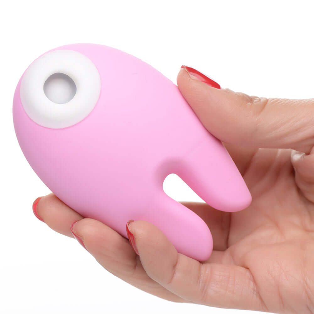 Shegasm Sucky Bunny Clitoral Stimulator Pink held in hand showcasing its cute design.