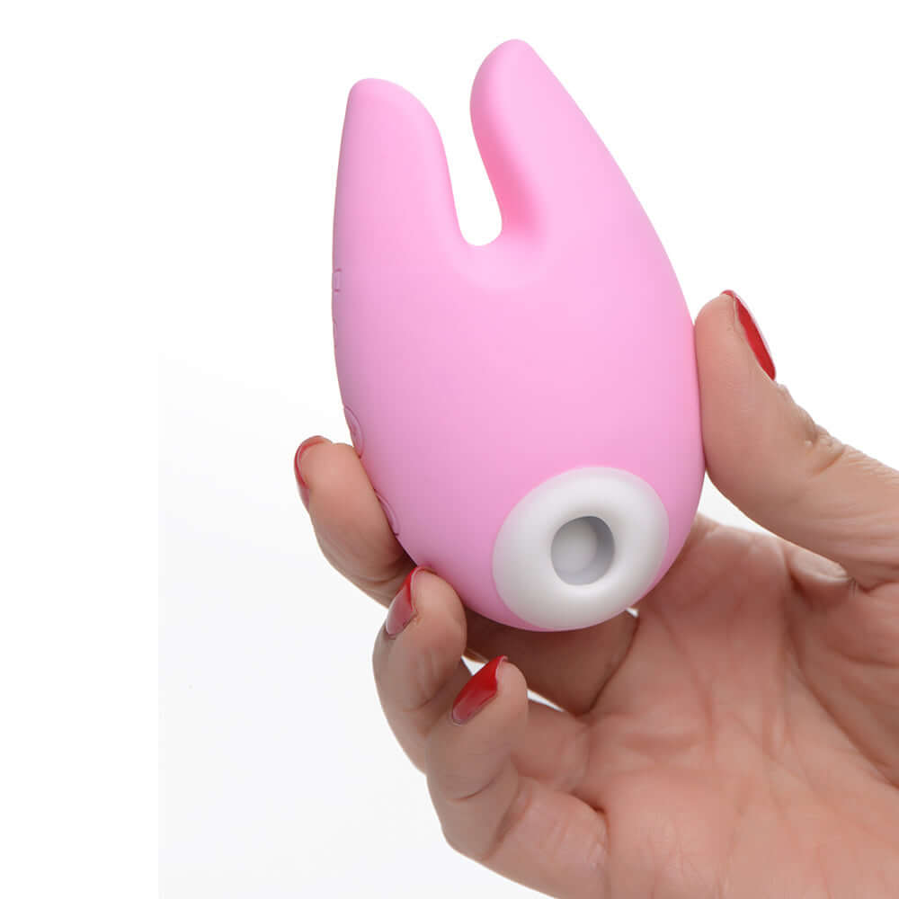 Shegasm Sucky Bunny Clitoral Stimulator Pink held in a hand, showcasing its cute design and functionality.