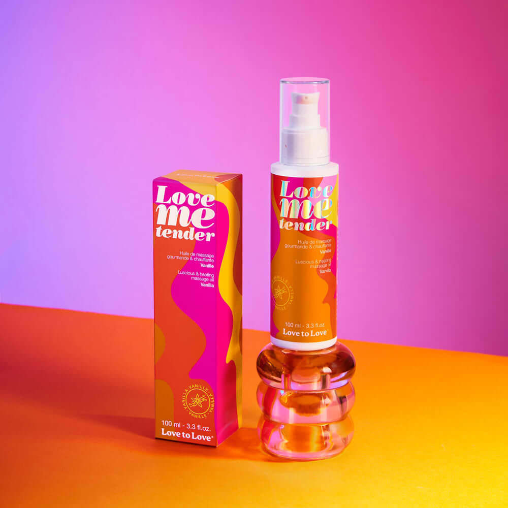 Love Me Tender Luscious & Heating Massage Oil Vanilla 3.3 Oz in a colorful packaging on a vibrant background.