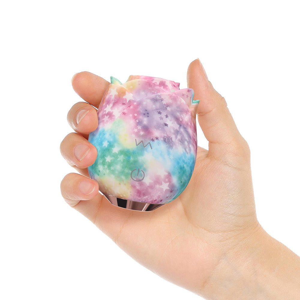 Adam and Eve Eves Ravishing Rose Tapping Clitoral Stimulator held in hand with a galaxy rainbow finish.