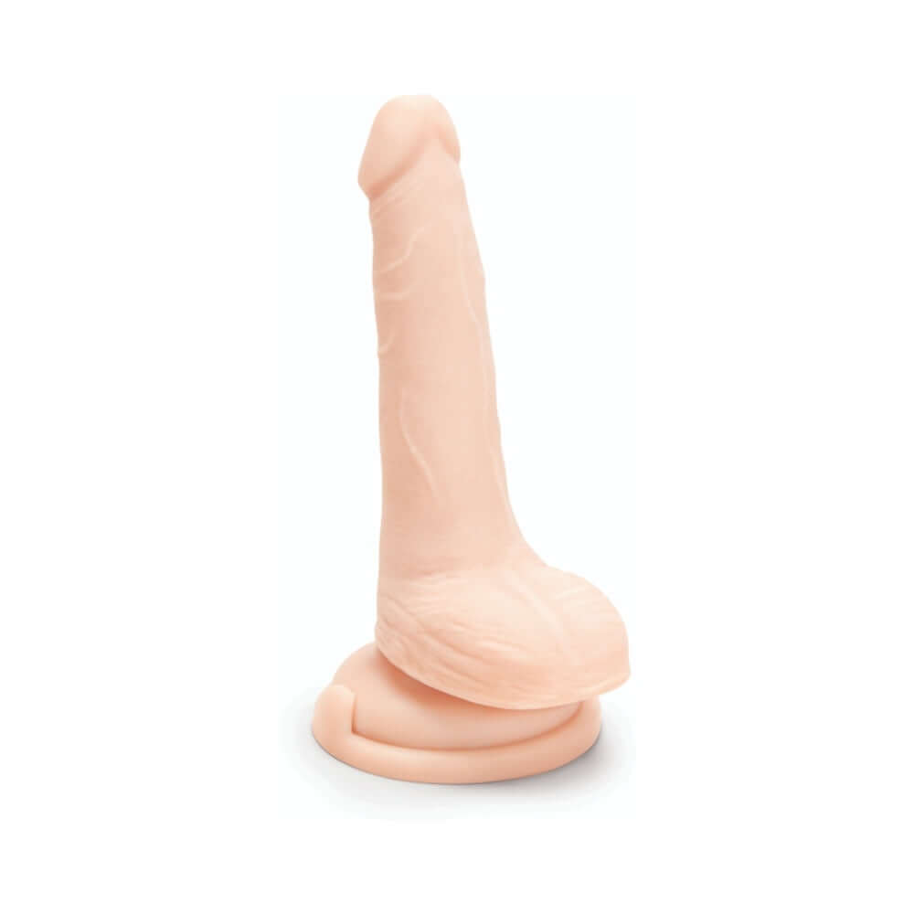 Prowler RED Ultra Cock 6 inch Dual Density Dildo with Balls Vanilla displayed on a base for stability.