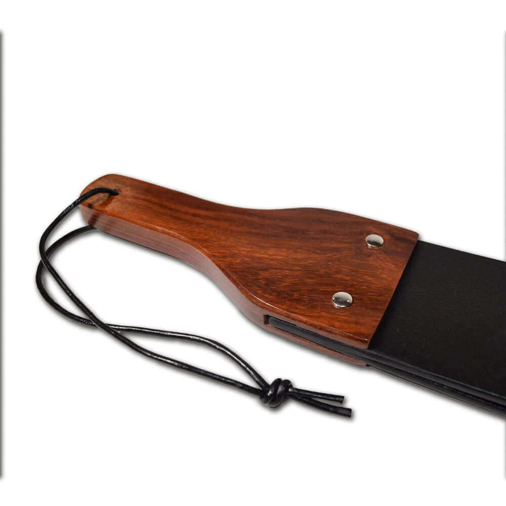 Close-up of the Prowler RED Leather & Wood Flapper Paddle showcasing its wooden handle and leather design.