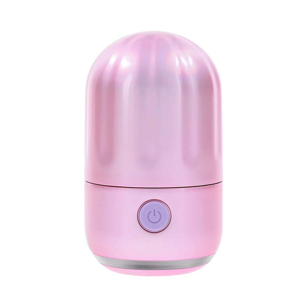 Evolved Vacation Vibes Tapping Massager in a pink-pearl iridescent design, showcasing its compact and stylish canister.