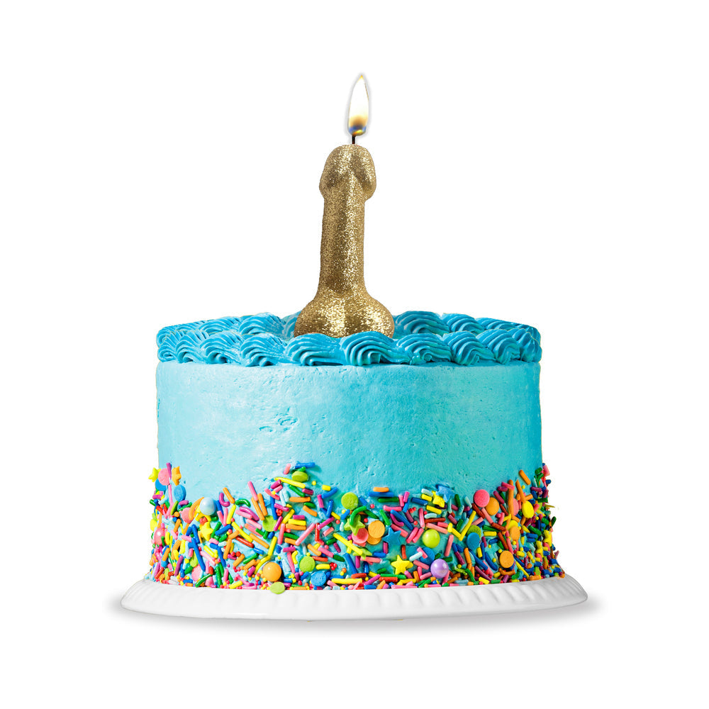 Golden Glitter Penis Candle atop a colorful birthday cake with blue frosting and sprinkles.