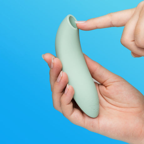 We-Vibe Melt 2 Pleasure Air Clitoral Stimulator Sage held in hand, showcasing its sleek design and user-friendly features.