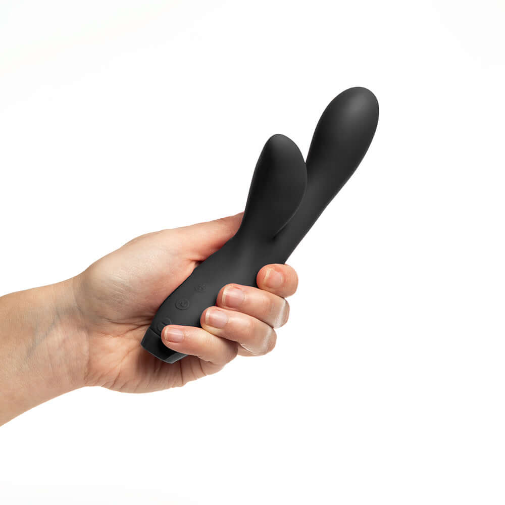 Person holding the Je Joue Hera Flex Dual Rabbit Vibrator, showcasing its sleek design and soft-touch silicone.