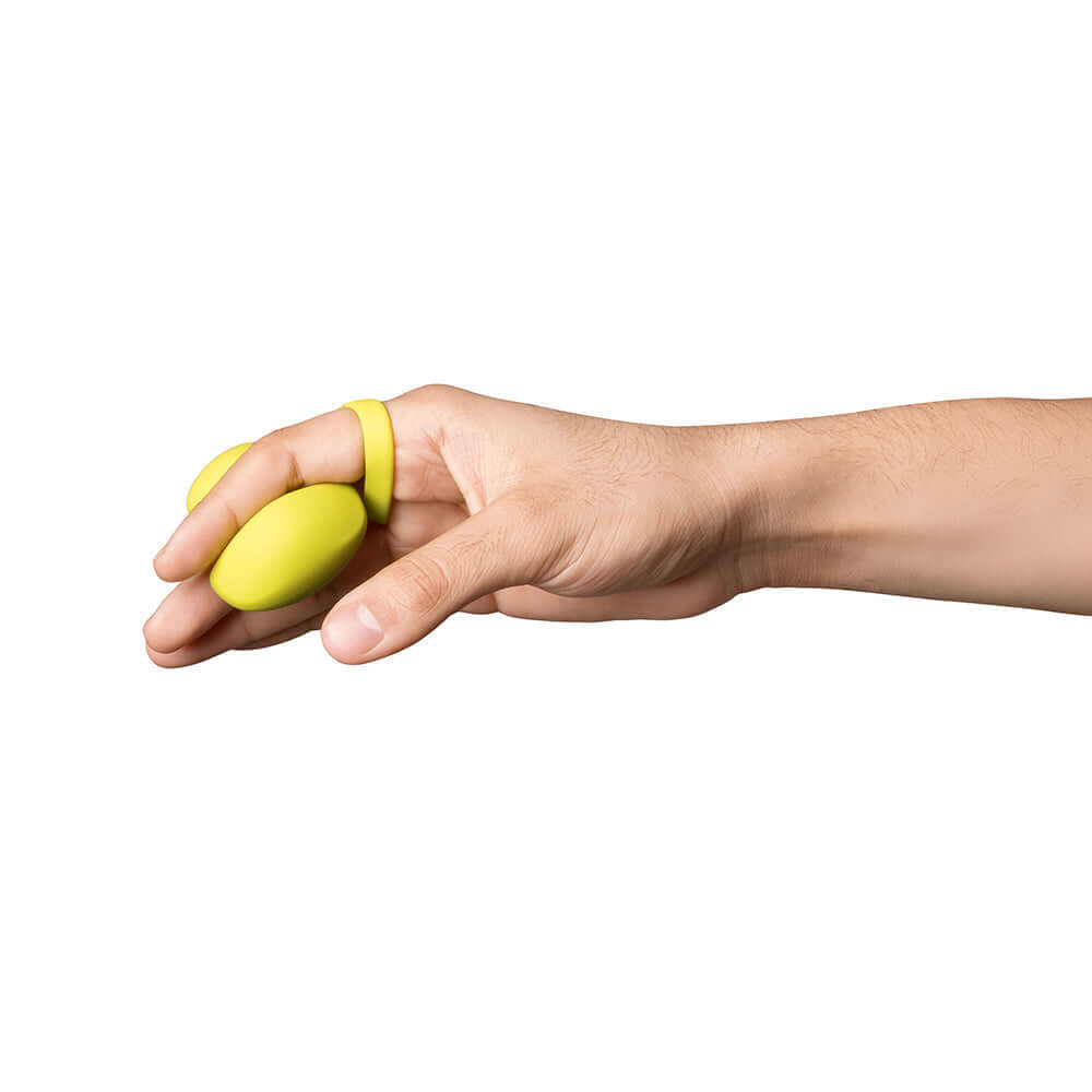 Dame Fin 2.0 Finger Vibrator Citrus held in a hand for intuitive and precise pleasure.